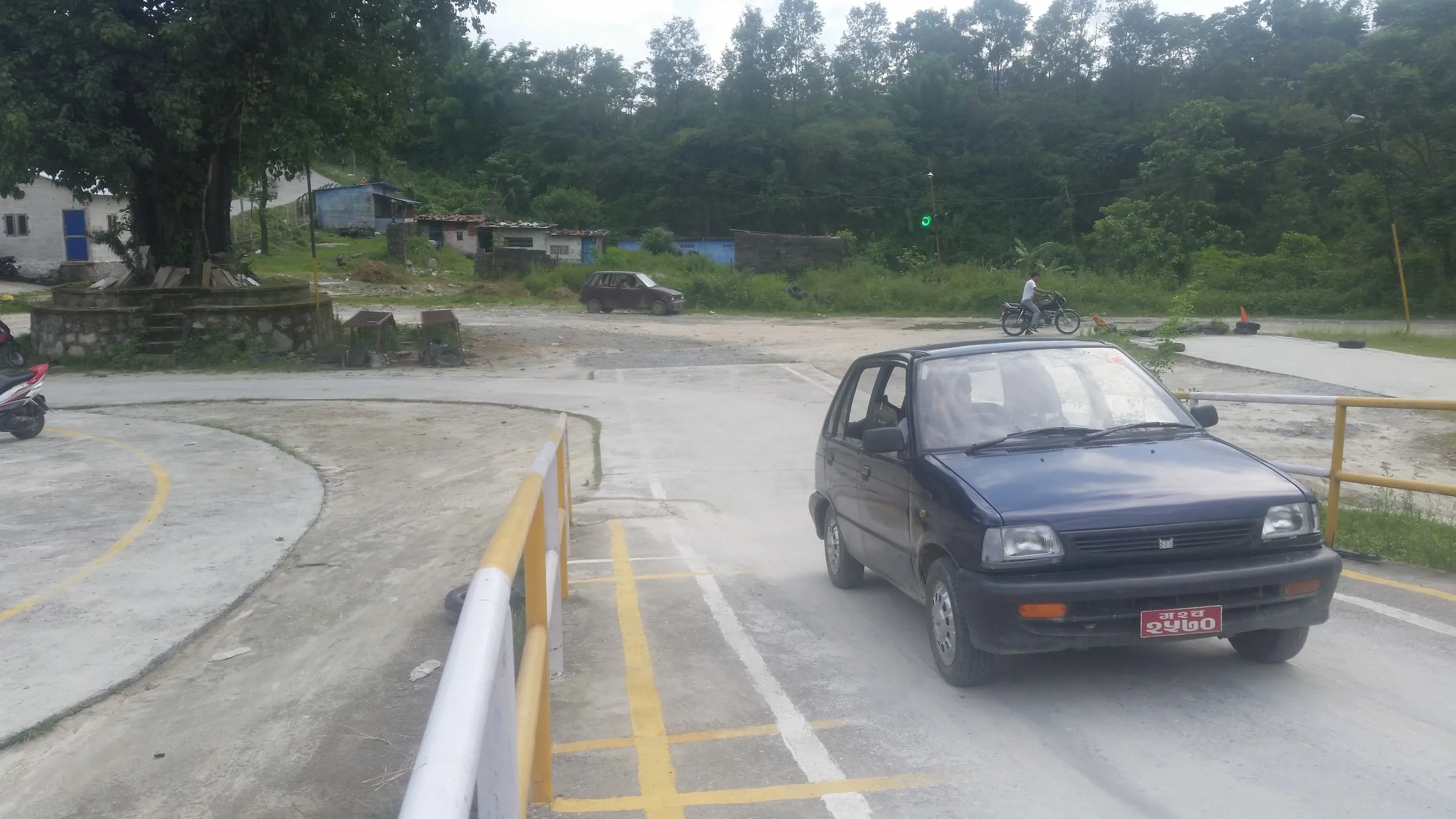 Student driving a compact car through the curve practice section