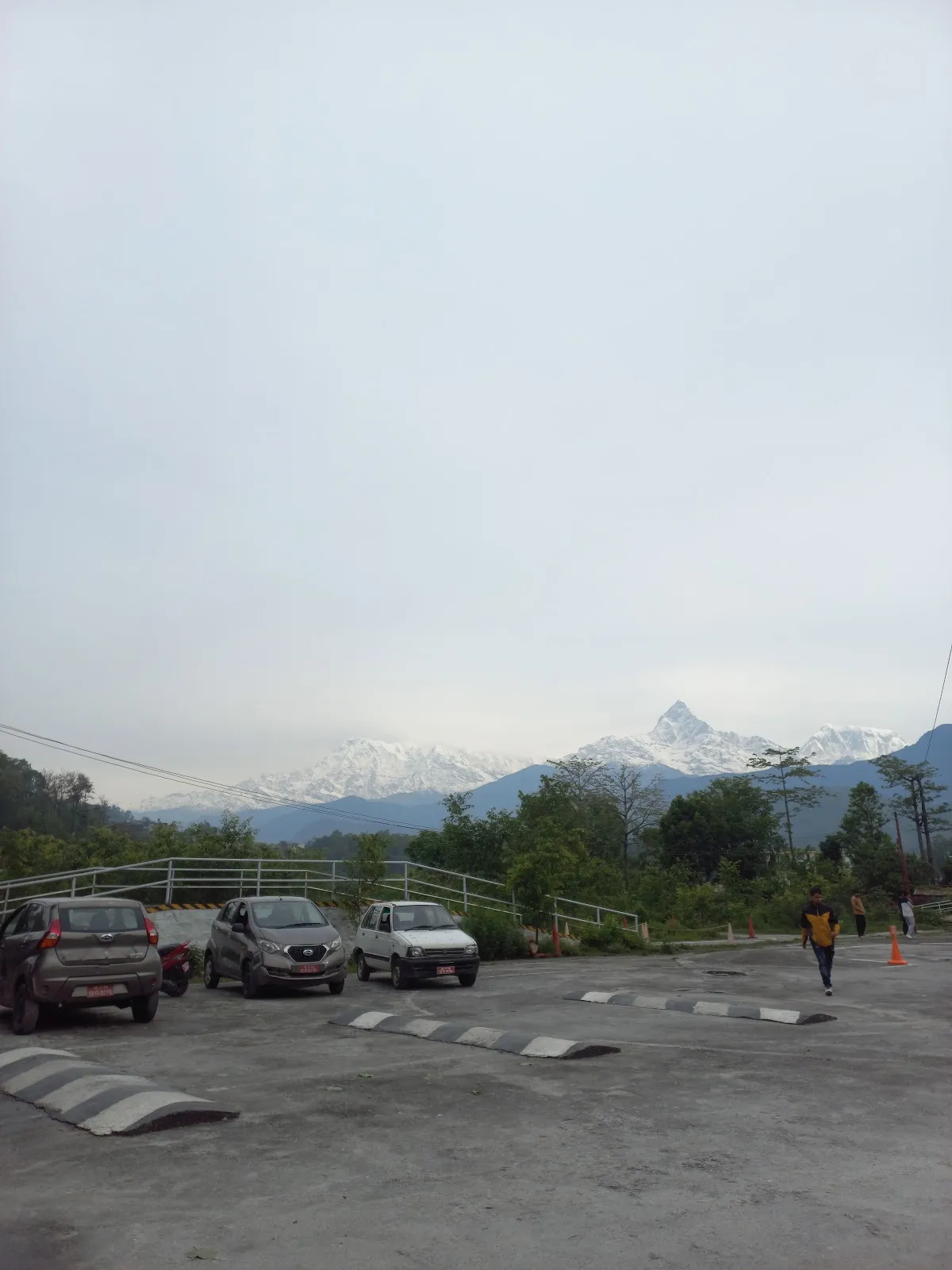 Training cars parked with the snowcapped Machapuchhre peak behind